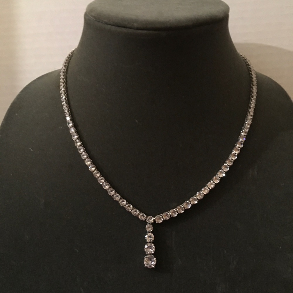 Silver diamond tennis necklace with infinity diamonds.